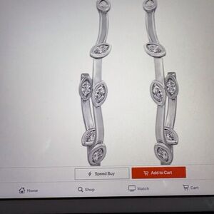 NIB DIAMONIQUE EARRINGS W/6 MARQUE STONES ON A VINE LIKE SETTING IN SILVER TONE.